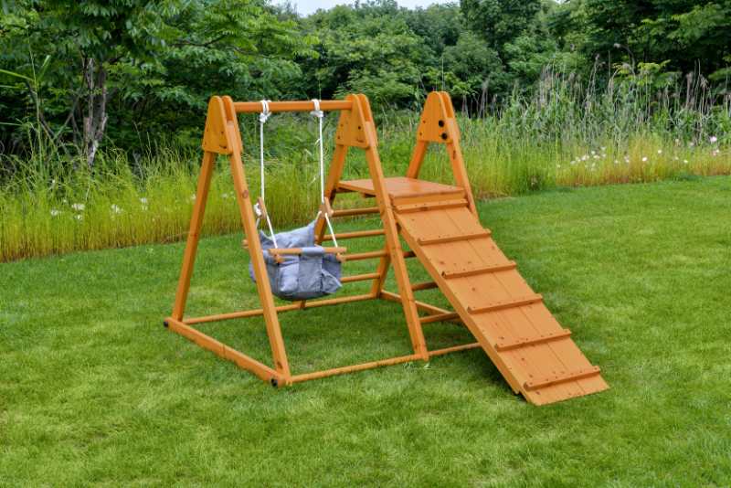 Foldable playset with slide, swings & rock wall - The Nurturing Nook