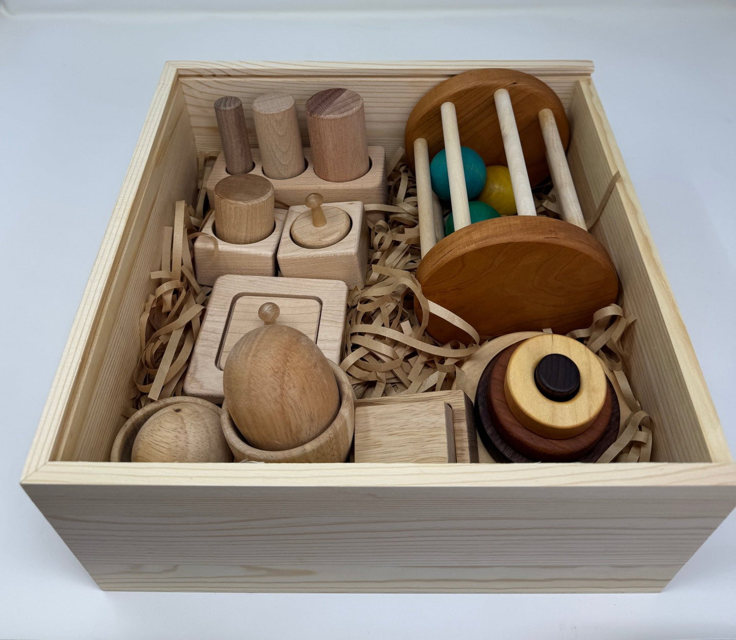 Montessori essentials gift box for 6 - 12 months – baby milestone gift with developmental toys, perfect for half - year celebrations - The Nurturing Nook