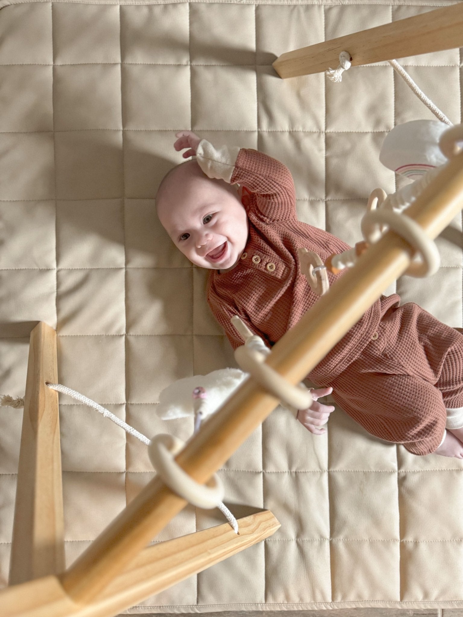 Wooden baby gym for sensory and motor play - The Nurturing Nook