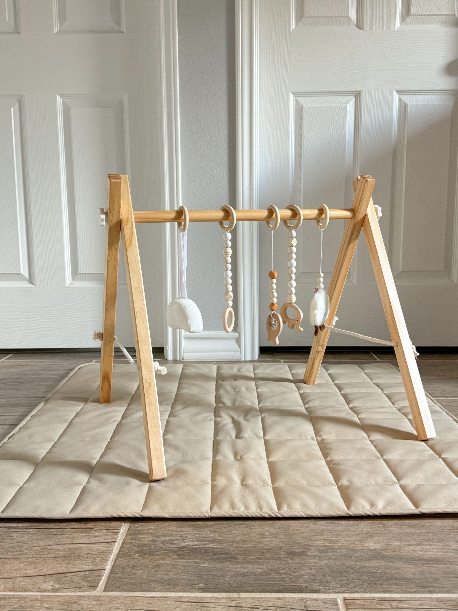 Wooden baby gym for sensory and motor play - The Nurturing Nook