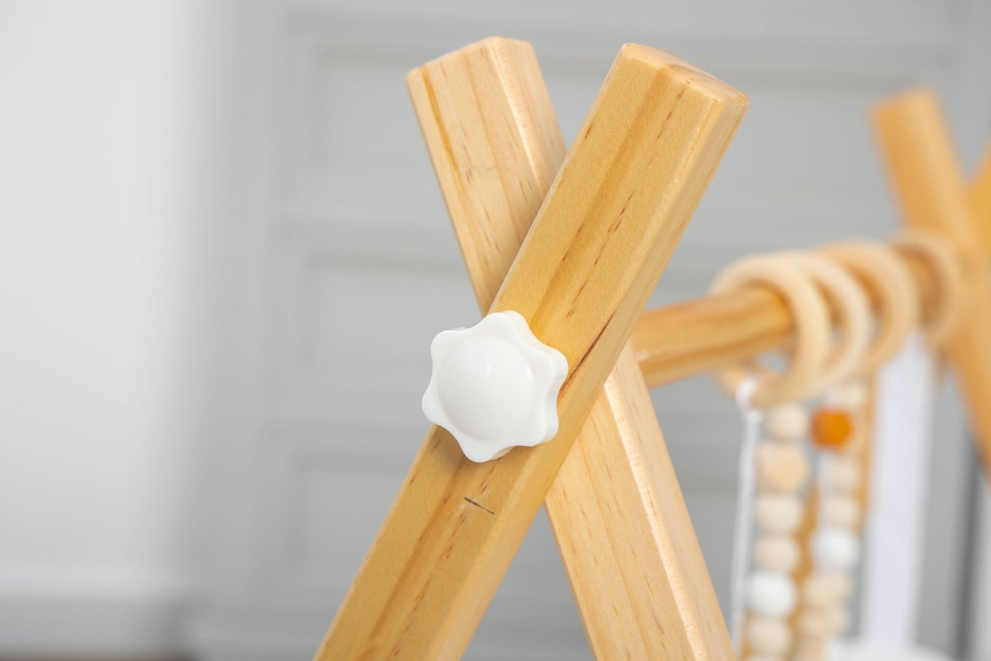 Wooden baby gym for sensory and motor play - The Nurturing Nook