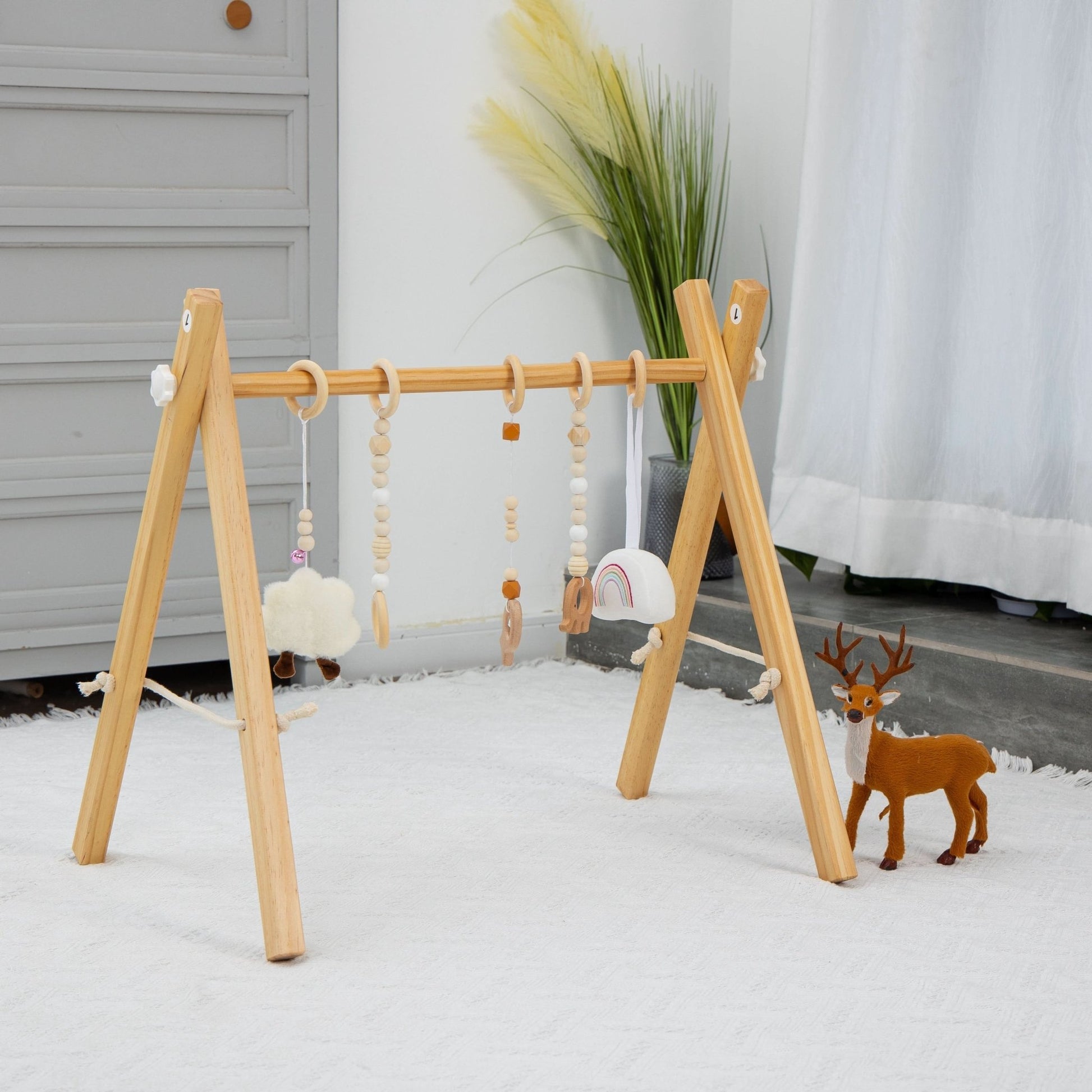 Wooden baby gym for sensory and motor play - The Nurturing Nook