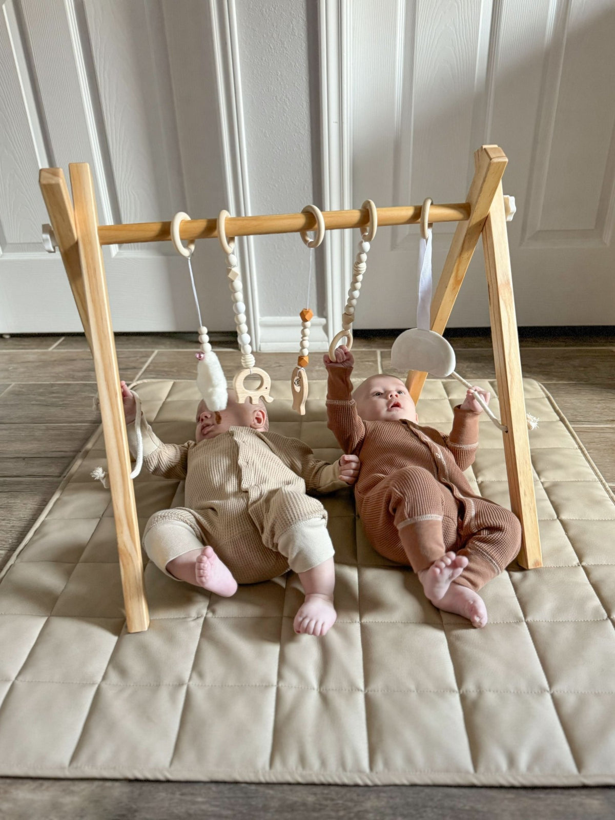 Wooden baby gym for sensory and motor play