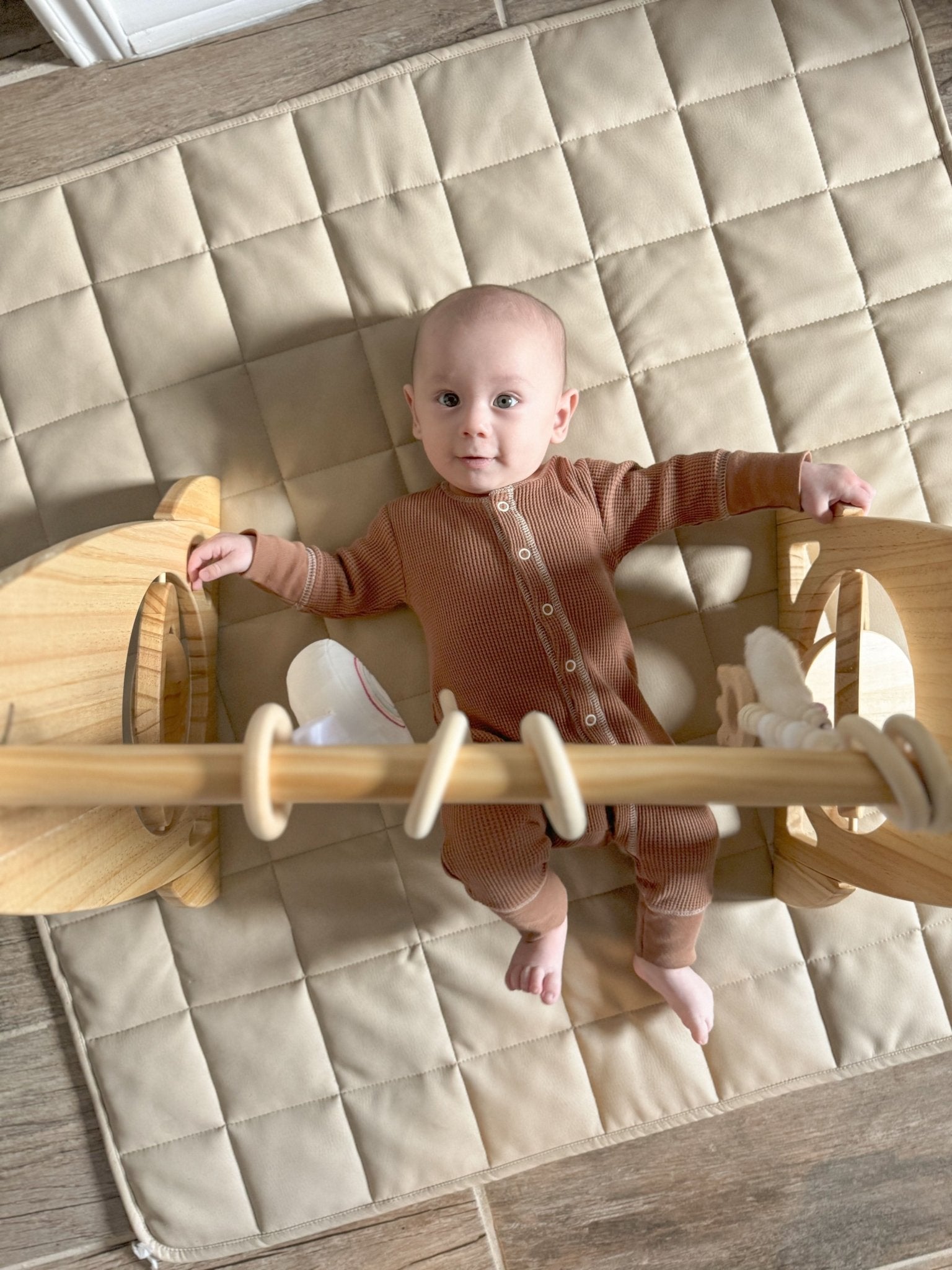 Wooden baby gym for sensory and motor play - The Nurturing Nook