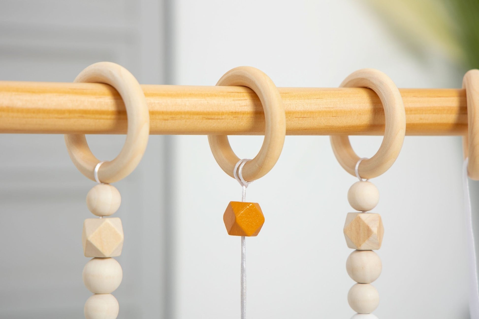 Wooden baby gym for sensory and motor play - The Nurturing Nook