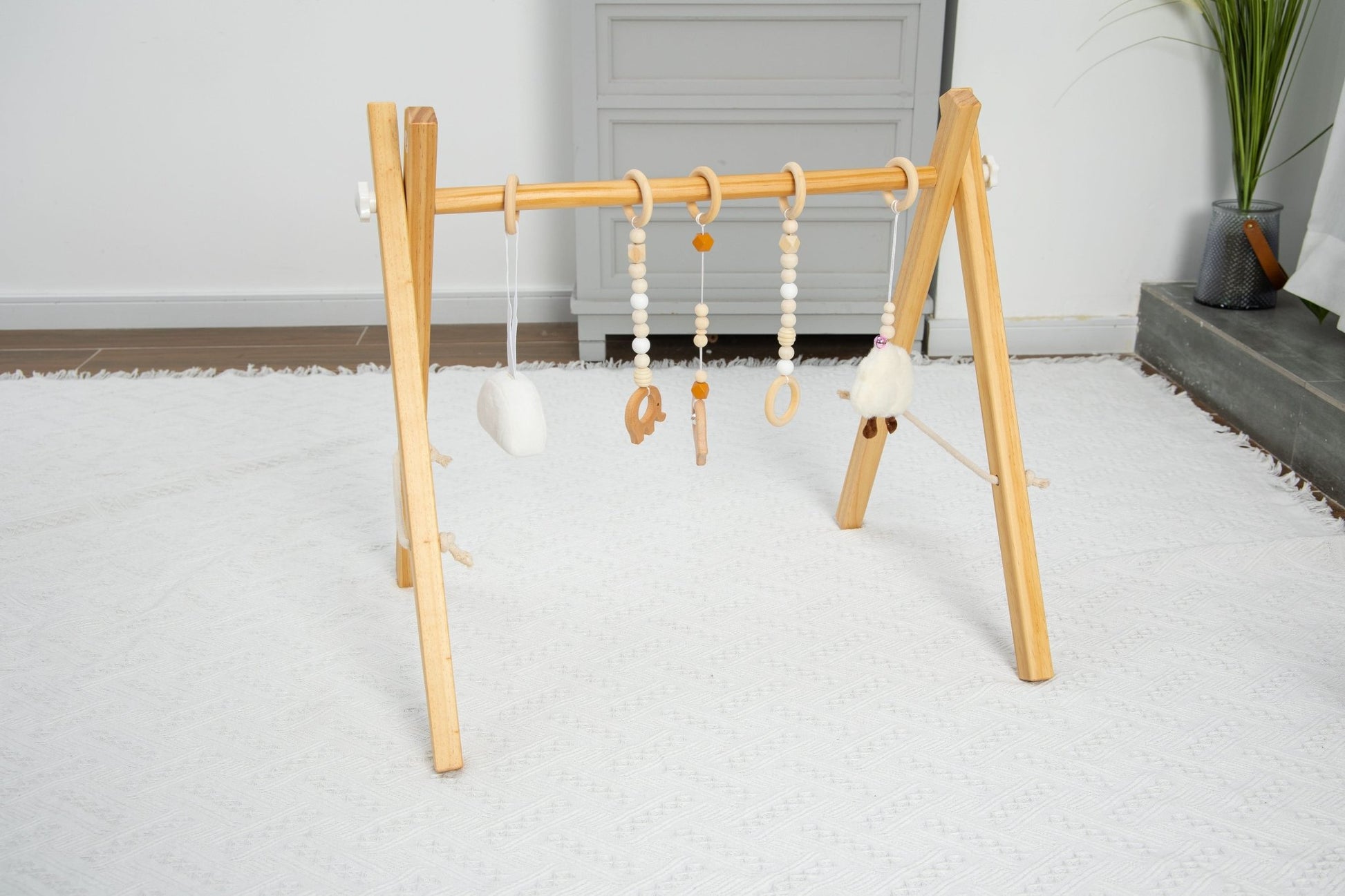 Wooden baby gym for sensory and motor play - The Nurturing Nook