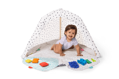 Montessori - aligned play gym for babies with sensory toys - The Nurturing Nook