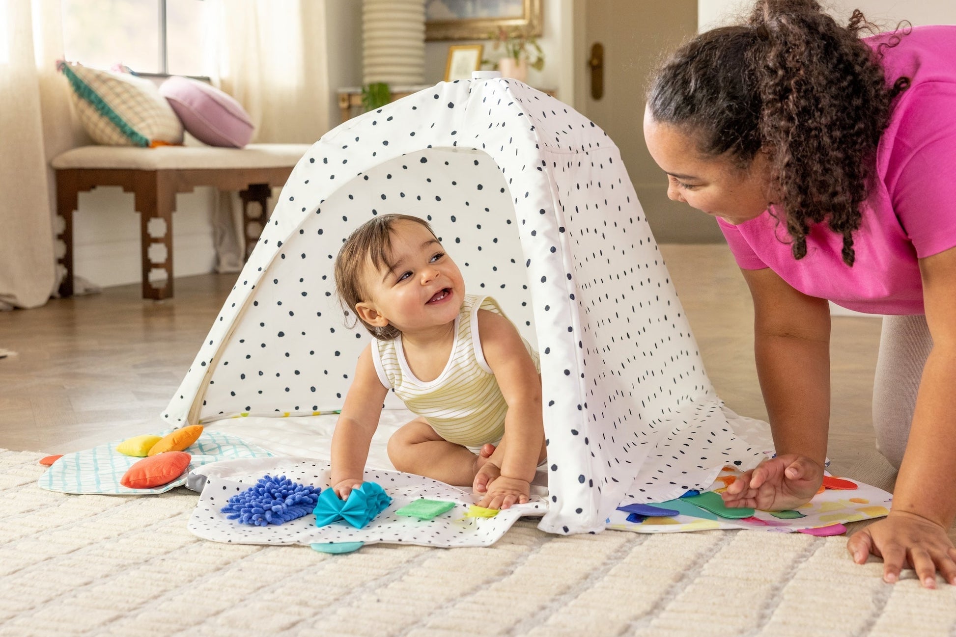 Montessori - aligned play gym for babies with sensory toys - The Nurturing Nook