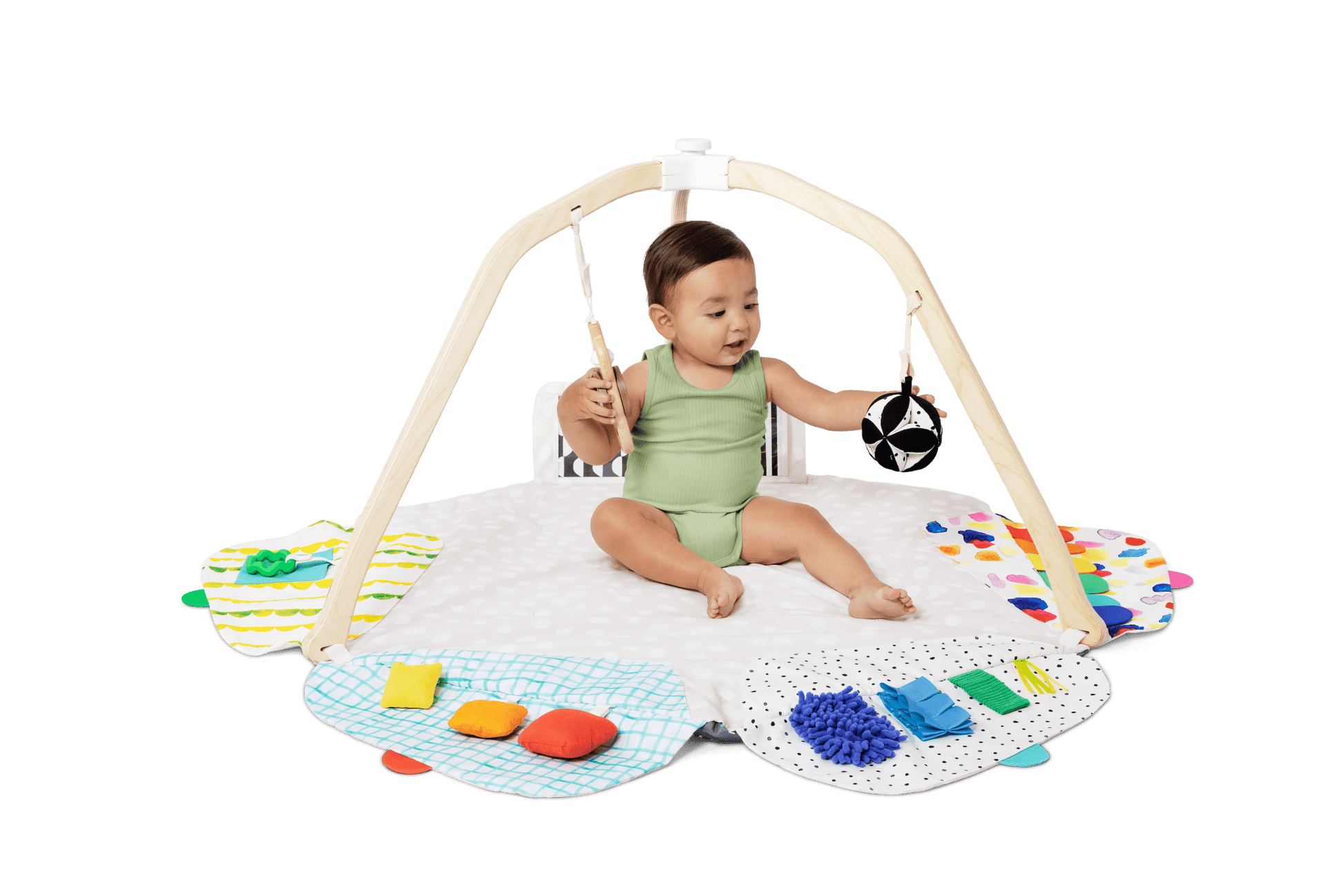 Montessori - aligned play gym for babies with sensory toys - The Nurturing Nook