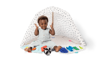 Montessori - aligned play gym for babies with sensory toys - The Nurturing Nook