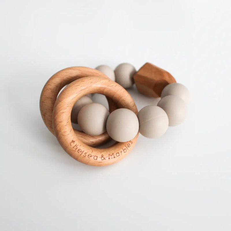Teething silicone rattle with wooden rings